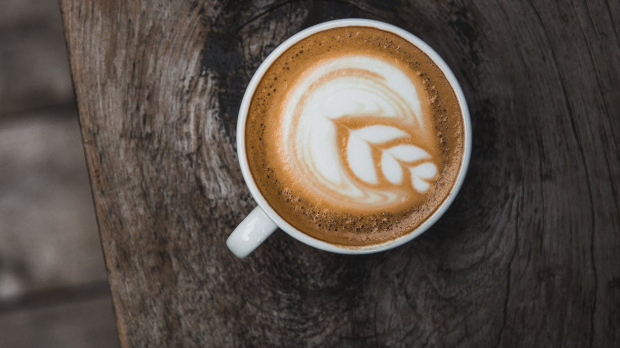 Cappuccino with latte art on a wooden surface